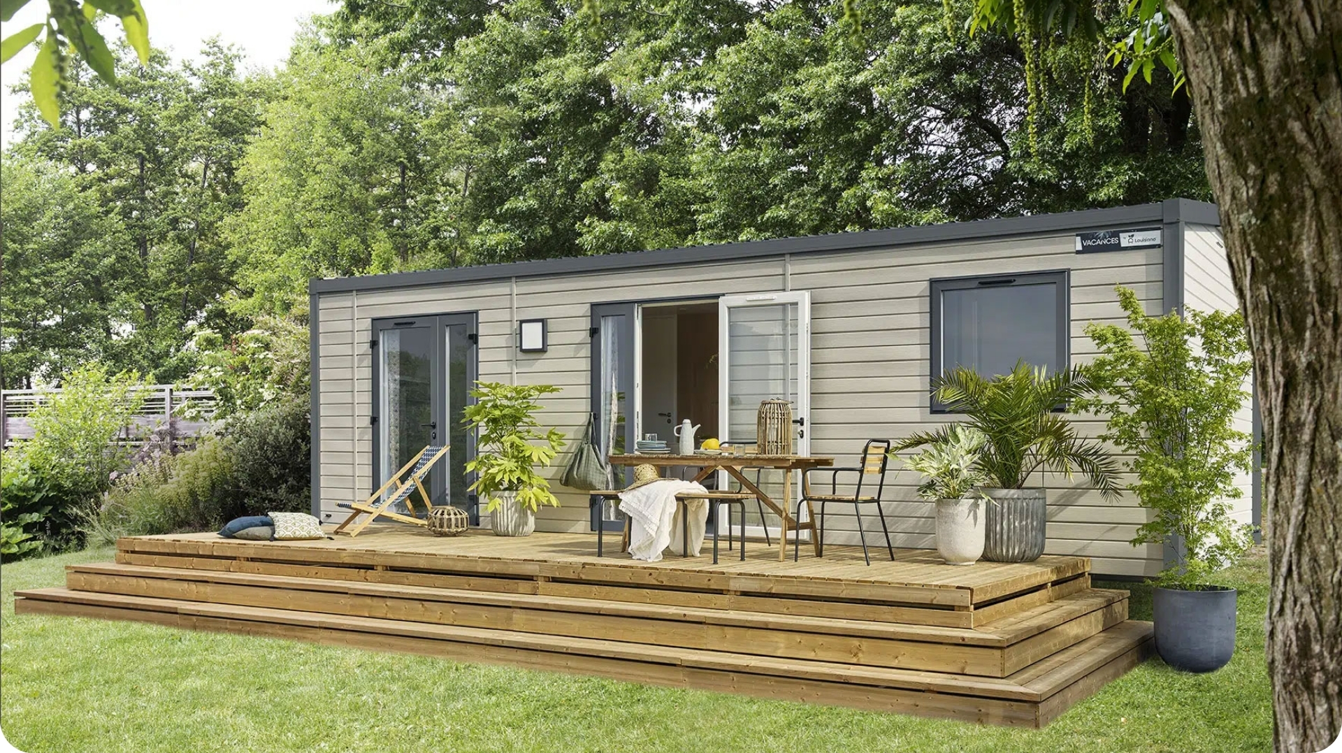 Exterior view of the 2-4 person mobile home with terrace, available for rent at the 3-star Le Paquier Fané campground in Saône-et-Loire